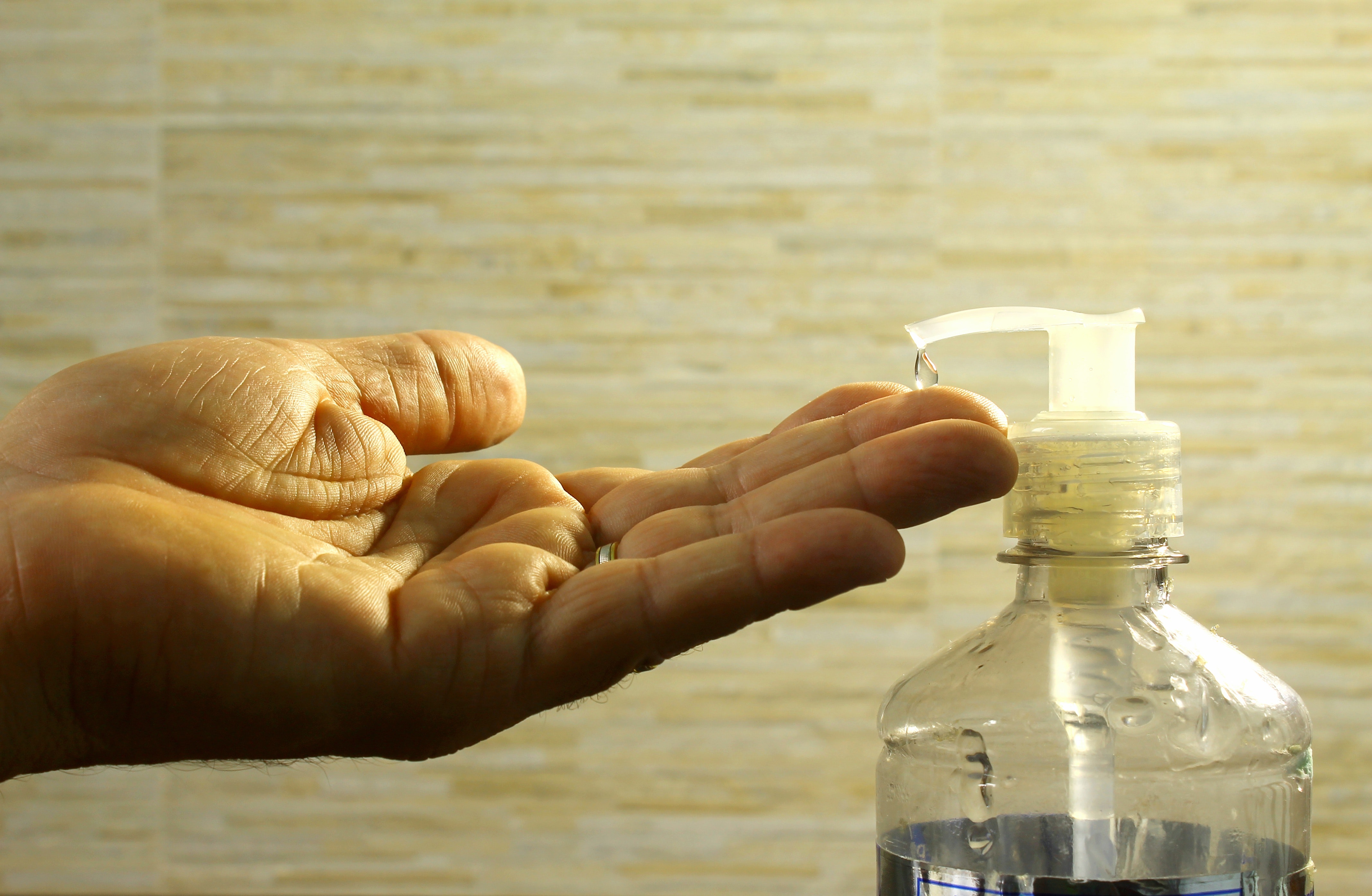 adult with OCD using hand sanitizer